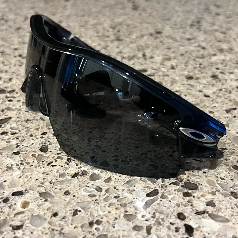 Never worn Men’s Oakley sunglasses with hard shell case.